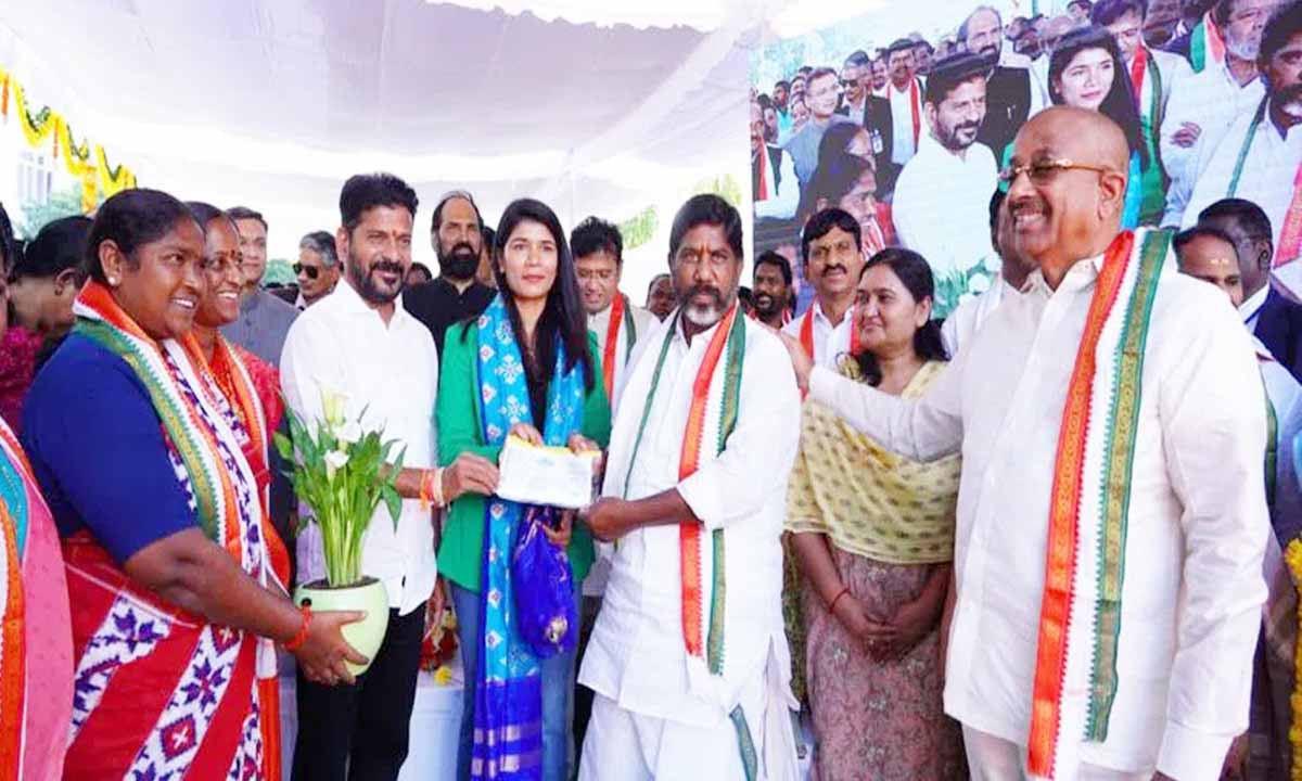 CM Revanth Reddy presents a check of Rs 2 crore to boxer Nikhat Zareen