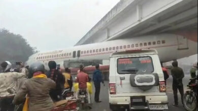 Airplane stuck under overbridge, crowd gathered to see the sight, see VIDEO