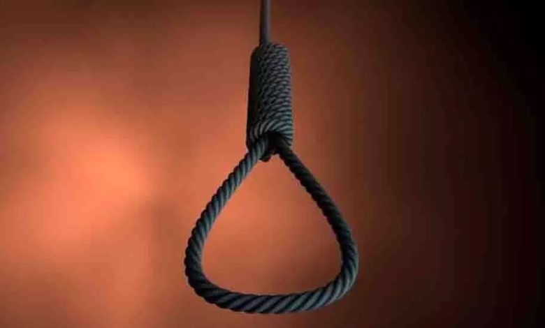 Middle aged man committed suicide by hanging himself from a tree