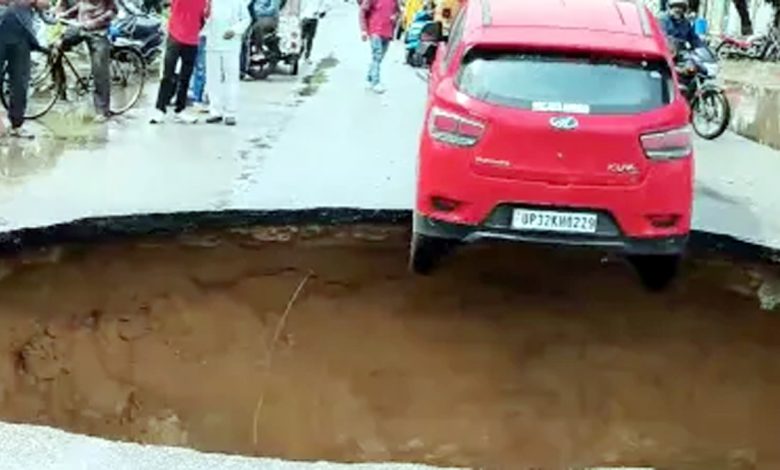 Car stuck in a pit on a road that has sunk due to rain in Lucknow, alert issued