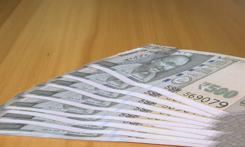 Rupee falls on weak global cues and FII outflows